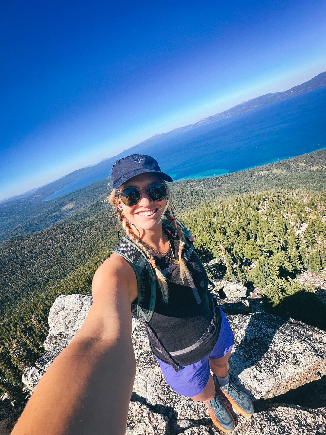 Amie Engerbretson standing on a mountain top.